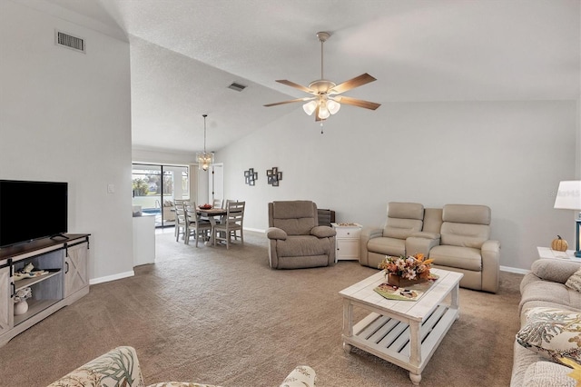 living room with ceiling fan with notable chandelier, carpet floors, and vaulted ceiling