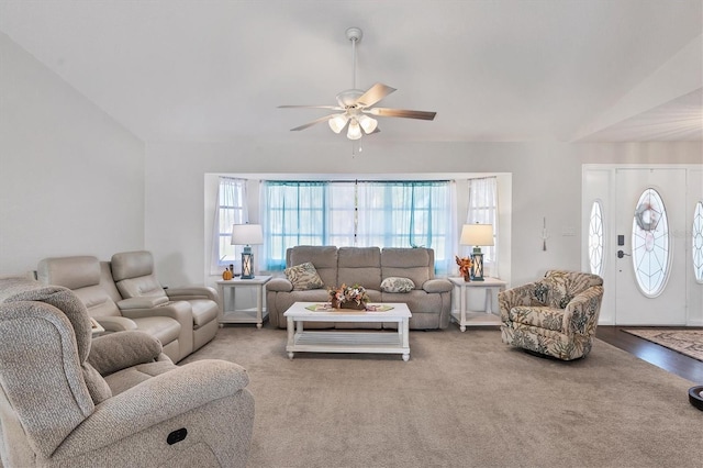 living room with carpet floors, vaulted ceiling, and ceiling fan