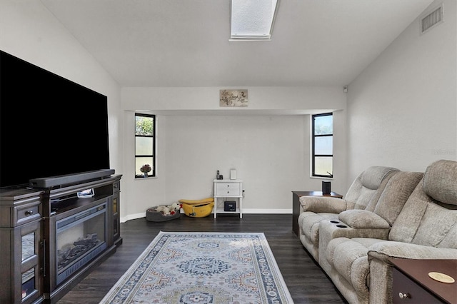 living room with dark hardwood / wood-style flooring and plenty of natural light