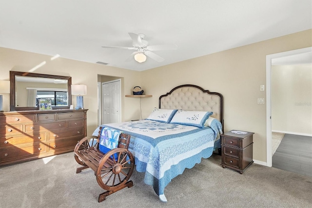 carpeted bedroom featuring ceiling fan and a closet