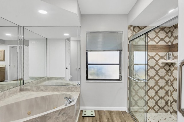 bathroom featuring plus walk in shower and hardwood / wood-style floors