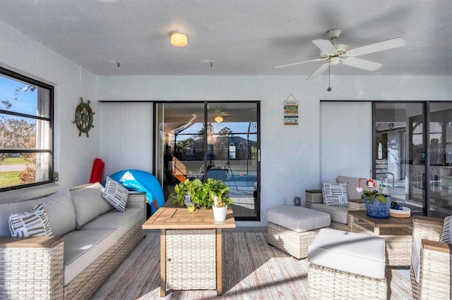 living room featuring hardwood / wood-style floors and ceiling fan