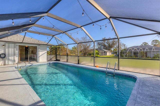 view of pool with a patio area and a lanai