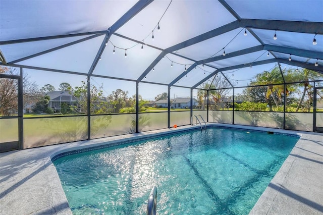 view of pool with a lanai, a patio area, and a water view