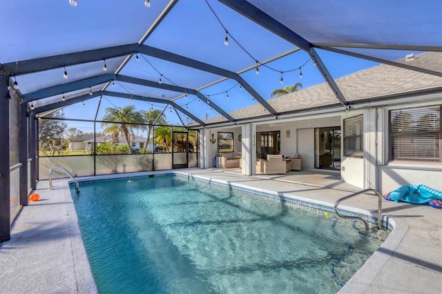 view of pool featuring glass enclosure, ceiling fan, an outdoor hangout area, and a patio