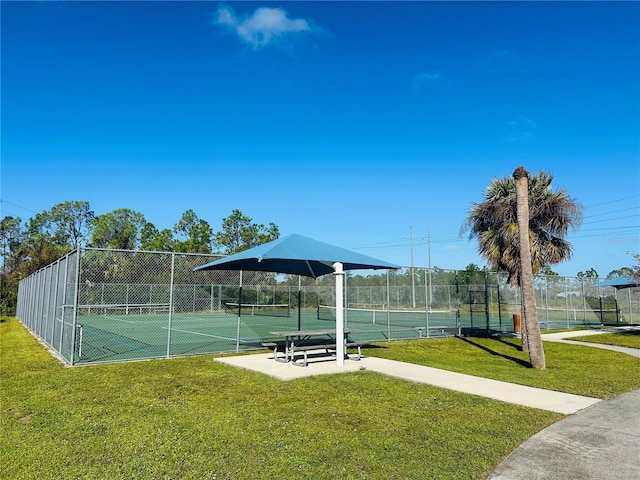 view of sport court with a yard