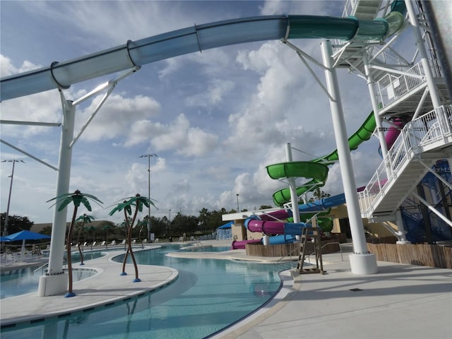 view of swimming pool featuring a water slide