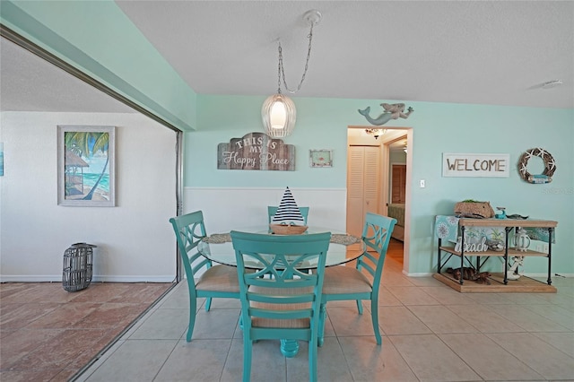 dining room with a textured ceiling and tile patterned floors