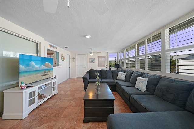 living room featuring a textured ceiling and ceiling fan