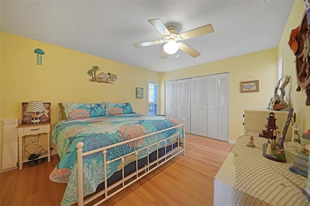 bedroom featuring wood-type flooring, ceiling fan, and a closet