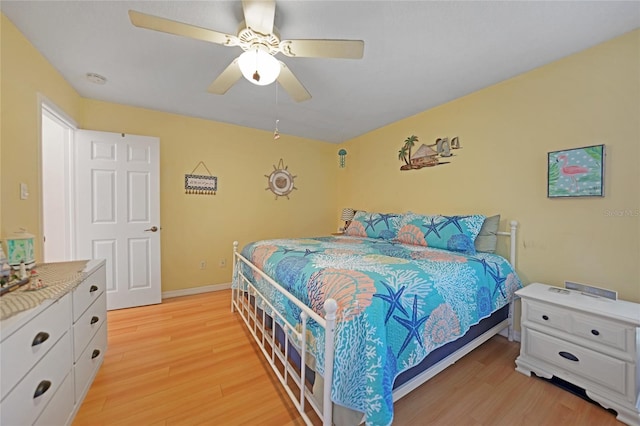 bedroom with light hardwood / wood-style floors and ceiling fan