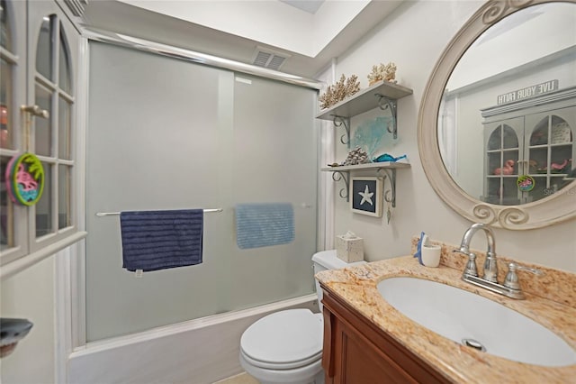 full bathroom with vanity, toilet, and enclosed tub / shower combo