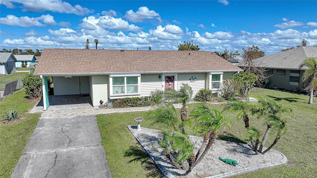 ranch-style house featuring a carport and a front lawn