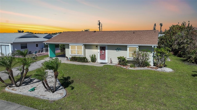 ranch-style home featuring a yard