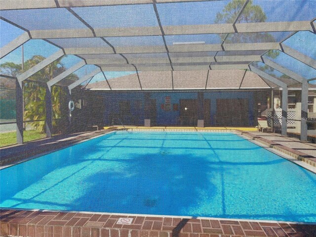 view of pool featuring a patio area and glass enclosure