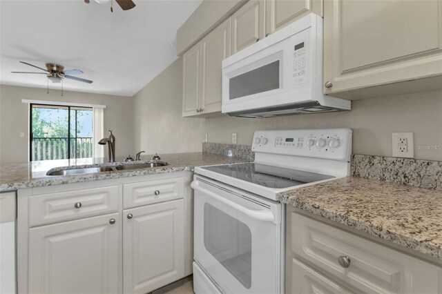 kitchen with white cabinets, ceiling fan, sink, and white appliances