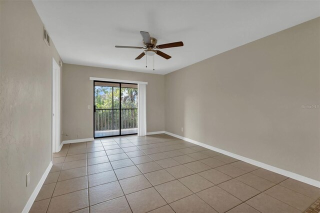 empty room featuring light tile patterned flooring and ceiling fan