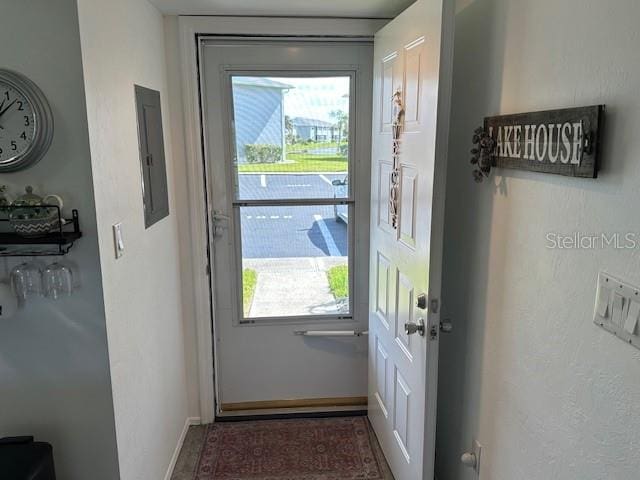 doorway to outside featuring electric panel