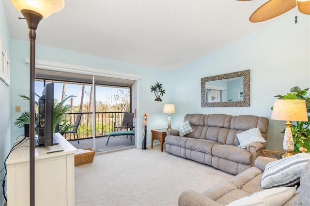 carpeted living room featuring ceiling fan and lofted ceiling