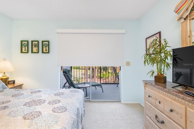 bedroom with access to exterior, light colored carpet, and baseboards