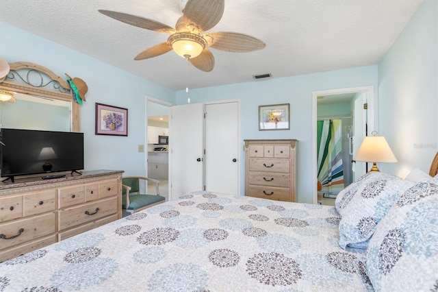 bedroom featuring a textured ceiling and ceiling fan