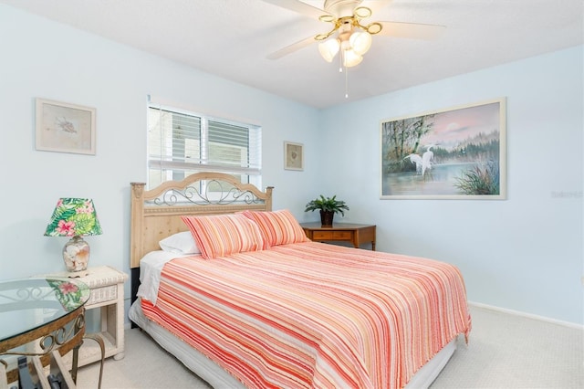 bedroom with a ceiling fan, carpet flooring, and baseboards