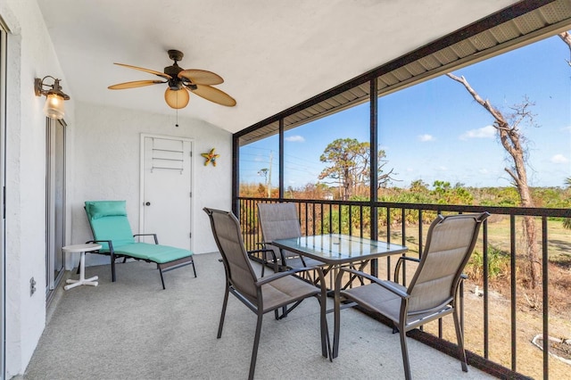 sunroom / solarium featuring ceiling fan and lofted ceiling