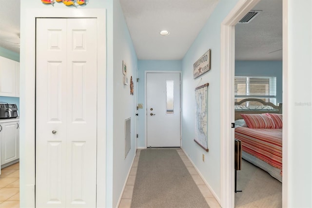 doorway to outside with light tile patterned floors, baseboards, visible vents, and recessed lighting