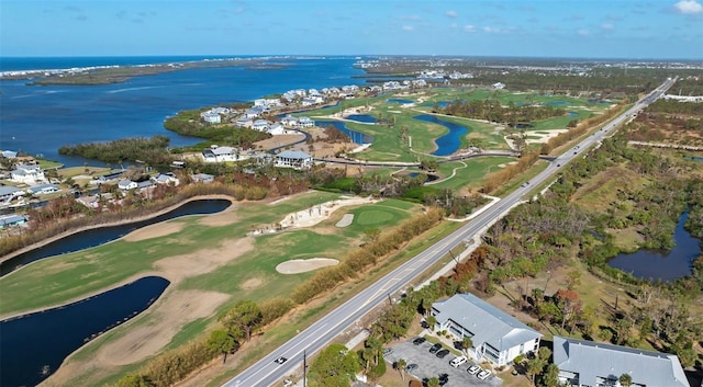 bird's eye view with a water view and view of golf course