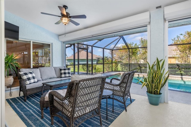 view of patio featuring a lanai, ceiling fan, and an outdoor hangout area