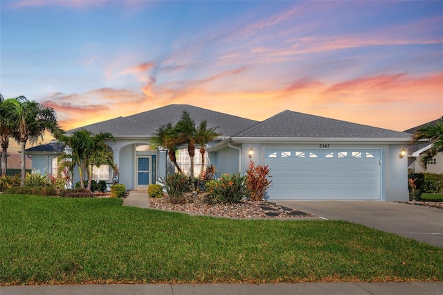 view of front of home featuring a yard and a garage