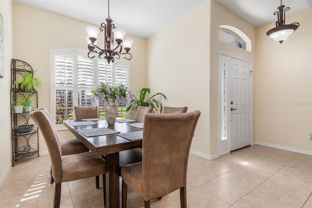 dining space with light tile patterned floors and an inviting chandelier