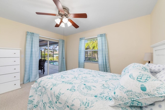 carpeted bedroom with access to exterior, multiple windows, and ceiling fan