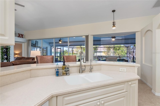 kitchen featuring light tile patterned flooring, pendant lighting, and sink