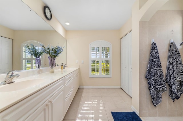 bathroom featuring tile patterned floors, vanity, and a healthy amount of sunlight