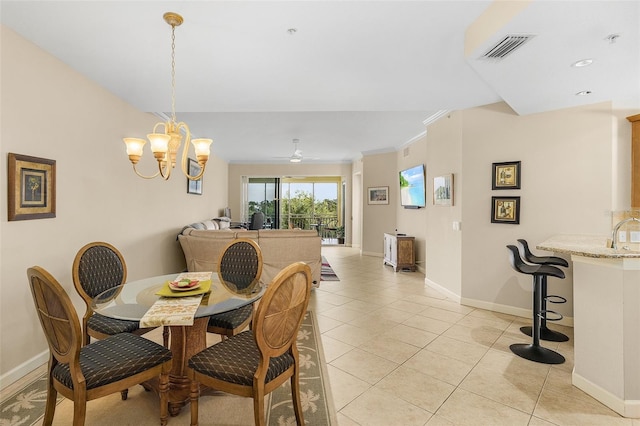 dining area featuring ornamental molding, ceiling fan with notable chandelier, and light tile patterned floors