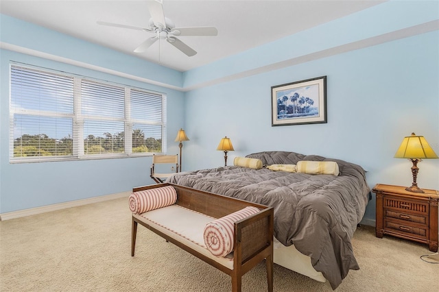 bedroom with ceiling fan and light carpet