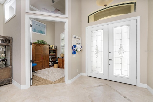 foyer entrance featuring french doors and light hardwood / wood-style floors