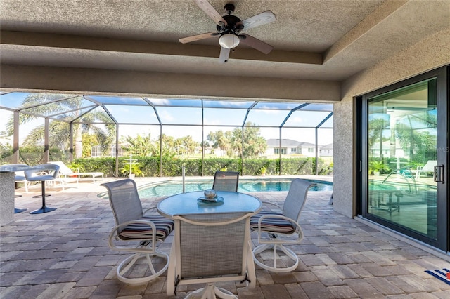 view of patio / terrace featuring ceiling fan and a lanai