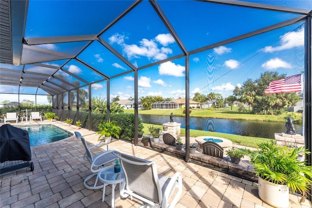 view of pool featuring a water view, a patio area, pool water feature, and glass enclosure