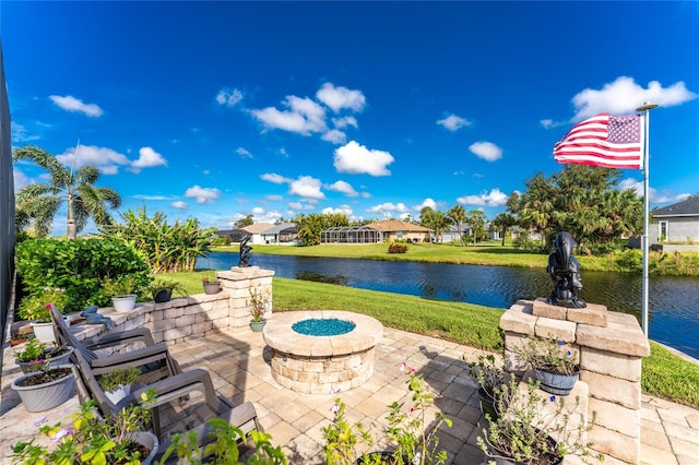 view of patio featuring an outdoor fire pit and a water view