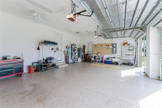 garage featuring a garage door opener, water heater, electric panel, and ceiling fan