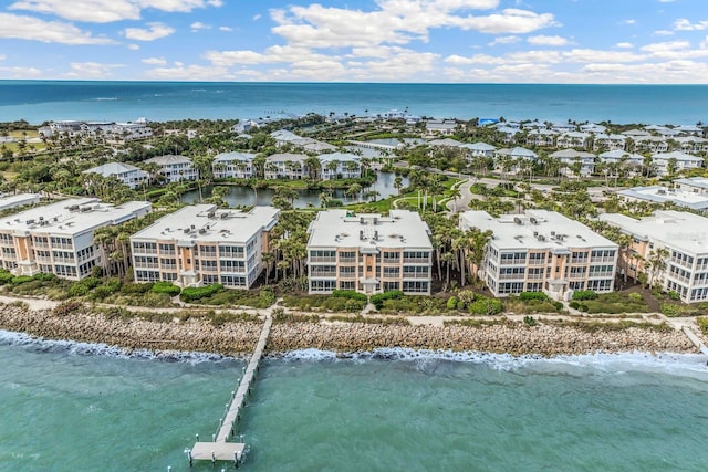 drone / aerial view with a water view and a beach view