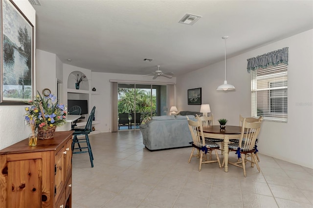 dining space with ceiling fan and light tile patterned floors