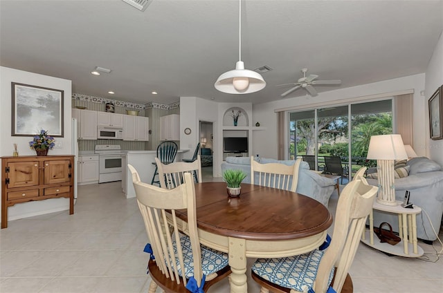 dining area with light tile patterned floors and ceiling fan