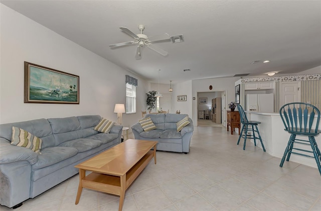 living room with ceiling fan and light tile patterned floors