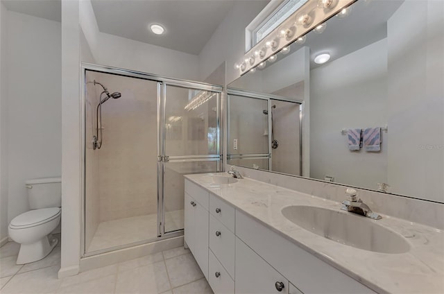 bathroom featuring vanity, tile patterned flooring, toilet, and walk in shower