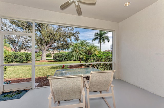 sunroom with plenty of natural light and ceiling fan