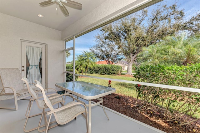 sunroom featuring ceiling fan