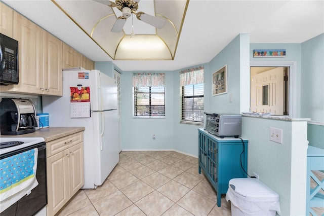 404 Pine Hollow Cir Unit 404, Englewood, FL 34223 - kitchen with black microwave, a ceiling fan, light countertops, electric range oven, and light tile patterned floors